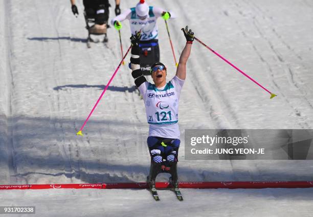Oksana Masters of the US celebrates her victory after crossing the finish line in the women's 1.1km sprint sitting cross-country skiing final event...