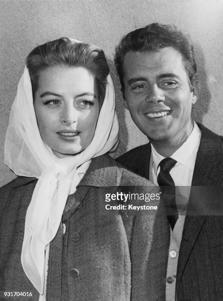 French actress Capucine is met by English actor Dirk Bogarde upon her arrival at London Airport from New York, 17th August 1960. She is in the UK to...