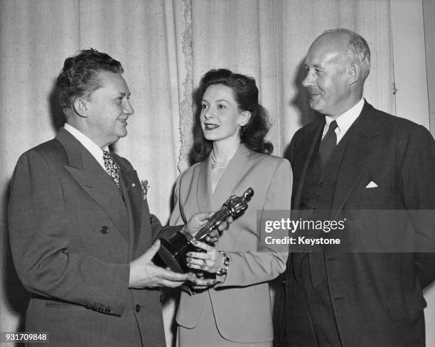 John Carvel , the British Consul General in Los Angeles, receives an Academy Award from actors Deborah Kerr and Jean Hersholt on behalf of British...