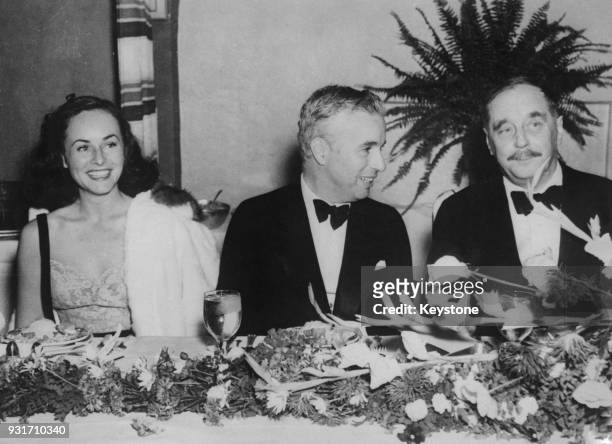 From left to right, American actress Paulette Goddard , English actor and filmmaker Charlie Chaplin and writer H. G. Wells at a dinner at the...