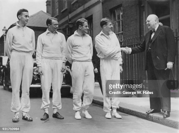 British Prime Minister Winston Churchill watches the first relay of runners, each carrying a cheque for £500, set off from Downing Street as part of...