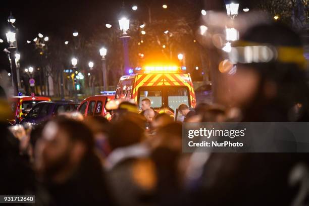 Emergency first responders are pictured after Kurds protesters clashed with police outside the US Embassy in Paris on March 13, 2018 during a...