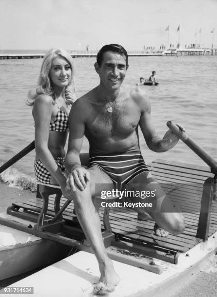 Italian actor Walter Chiari and American actress Linda Gaye Scott on the beach in Venice, Italy, during the Venice Film Festival, circa 1965.