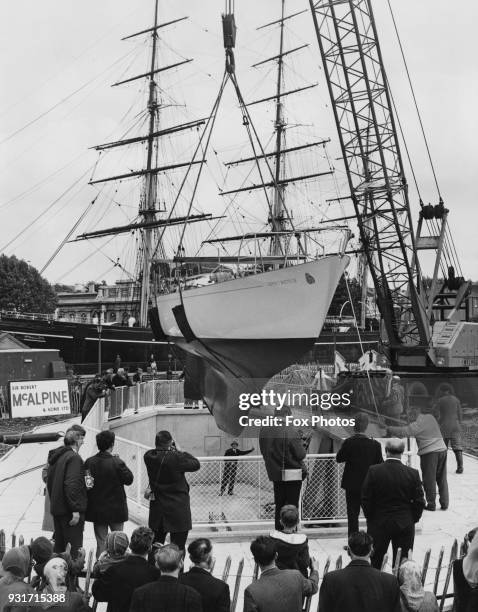 The ketch 'Gipsy Moth IV' in which Sir Francis Chichester sailed single-handed around the globe, is lowered into a dry dock in Greenwich, London,...