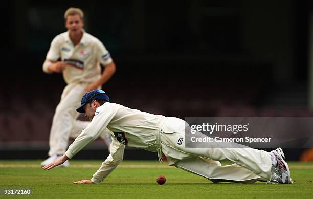 Michael Clarke of the Blues dives for the ball during day two of the Sheffield Shield match between the New South Wales Blues and the Tasmanian...