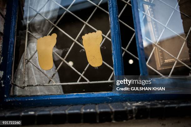 Paper cut-outs are pictured on a window inside the Childcare Orientation Centre in Klipspruit West, in Soweto, on March 13, 2017. Nine children under...