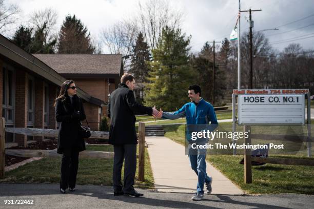 Democrat candidate Conor Lamb and Westmoreland County commissioner Gina Cerilli greet Ben Davis who voted for Republican candidate Rick Saccone at...