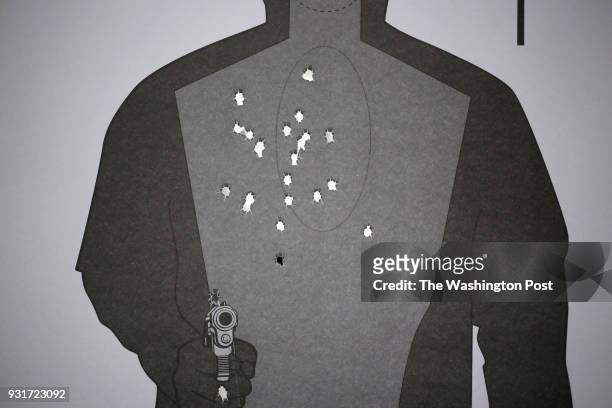 Paper target is pictured after being shot by firearms instructor Joe Eaton at Premier Shooting & Training Center in West Chester Township, Ohio. On...