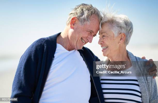 my first love, my forever love - older couple hugging on beach stock pictures, royalty-free photos & images