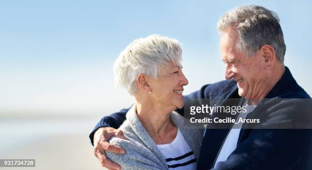 as time goes by i love you even more - older couple hugging on beach stock pictures, royalty-free photos & images