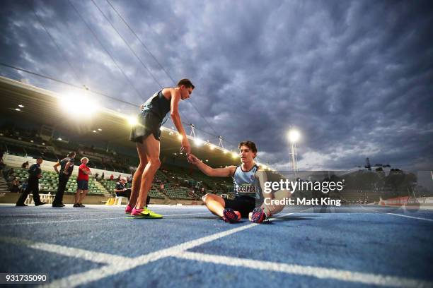 Jakob Madden and Luke Gosper of NSW rest after competing in the Men's 2000 Metre Steeplechase Under 18 during day one of the Australian Junior...