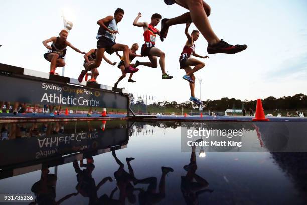 Competitors race in the Men's 2000 Metre Steeplechase Under 17 during day one of the Australian Junior Athletics Championships at Sydney Olympic Park...