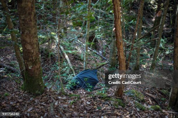 Discarded umbrella lies in Aokigahara forest on March 13, 2018 in Fujikawaguchiko, Japan. Aokigahara forest lies on the on the northwestern flank of...