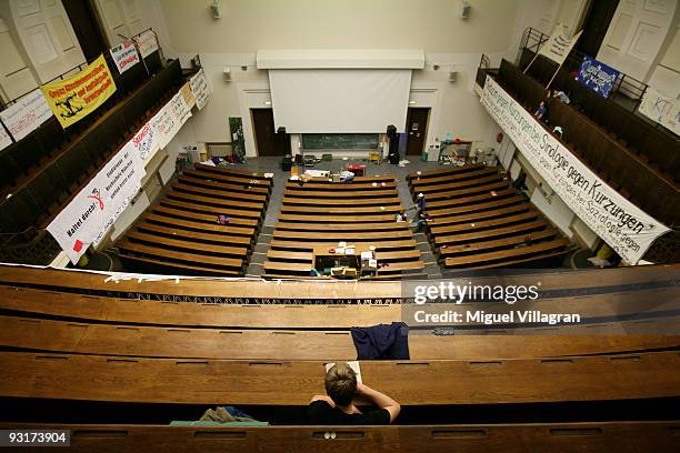 Student reads a book in the squatted main lecture hall of the Ludwig Maximilians university on November 18, 2009 in Munich, Germany. Following...