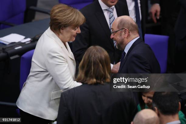 German Chancellor Angela Merkel receives congratulations from Social Democrat Martin Schulz, who ran against her in elections last year, following...