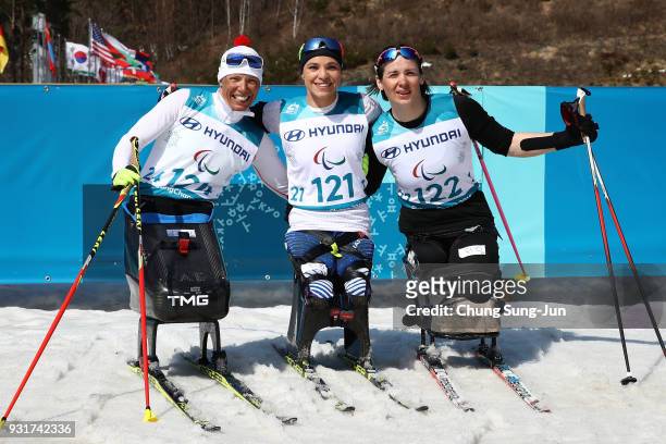 Gold medalist Oksana Masters of United States, Andrea Eskau of Germany and Bronze medalist Marta Zainullina of Neutral Paralympic Athlete celebrates...