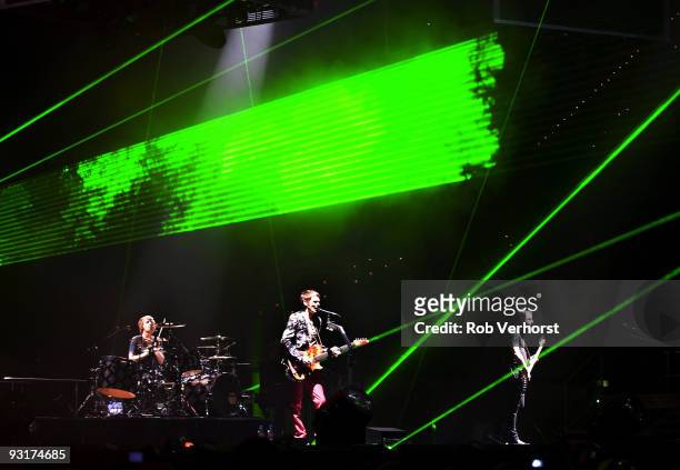 Dominic Howard, Matt Bellamy and Chris Wolstenholme of Muse performs on stage at Ahoy on November 14, 2009 in Rotterdam, Netherlands.