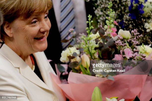 German Chancellor Angela Merkel receives congratulations from parliamentarians following her election by the Bundestag for a fourth term as...