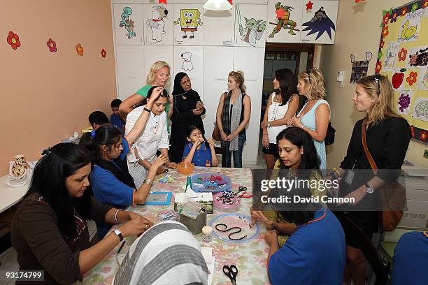 Emma Stenson, Sanna Hanson, Charlotte Kjeldsen, Dianna Donald, and Lauren Smith interact with the children during the European Tour Wives Association...