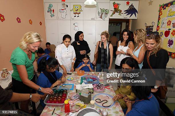 Emma Stenson, Sanna Hanson, Charlotte Kjeldsen, Dianna Donald, and Lauren Smith interact with the children during the European Tour Wives Association...