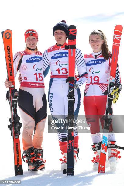 Silver medalist Andrea Rothfuss of Germany, Gold Medalist Marie Bochet of France and Mollie Jepsen of Canada celebrates at the victory ceremony for...