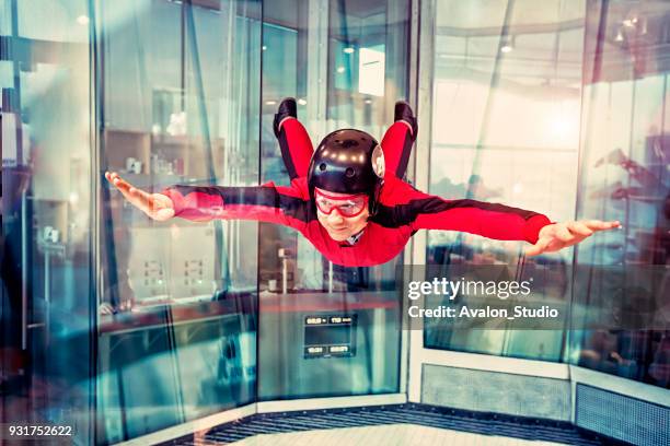 free flight in the wind tunnel. - red plane stock pictures, royalty-free photos & images