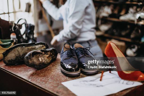 female shoemaker working at the shop - cobbler stock pictures, royalty-free photos & images