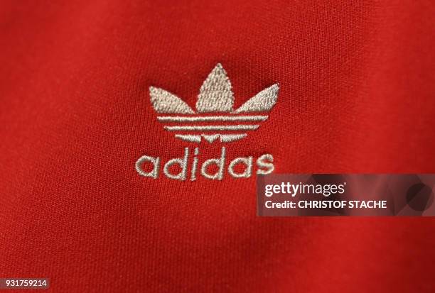 The Adidas company logo is on display on a shirt during the company's annual press conference of Germany's sportgoods company Adidas in...