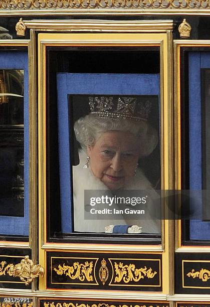 Queen Elizabeth II leaves Buckingham Palace in a carriage for the Houses of Parliament before the State Opening of Parliament on November 18, 2009 in...