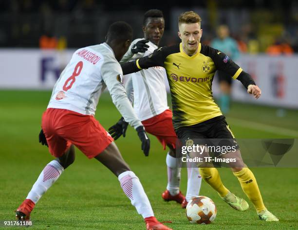 Diadie Samassekou of Salzburg and Marco Reus of Dortmund battle for the ball during UEFA Europa League Round of 16 match between Borussia Dortmund...