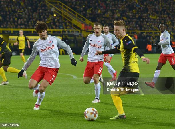 Diadie Samassekou of Salzburg and Marco Reus of Dortmund battle for the ball during UEFA Europa League Round of 16 match between Borussia Dortmund...
