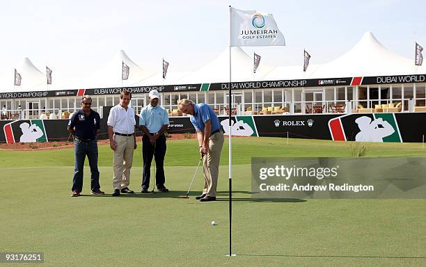 Greg Norman, designer of the Earth Course, takes a putt whilst being watched by Saeed Harib of Nakheel Leisure, George O'Grady, Chief Executive of...