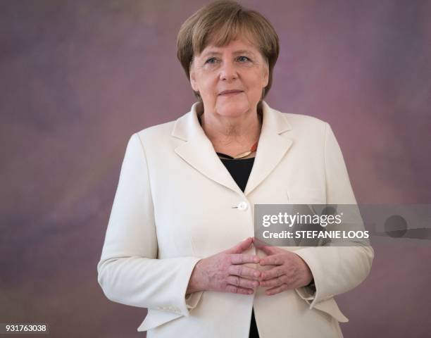 German Chancellor Angela Merkel waits to be given her certificate of appointment by the German President on March 14, 2018 at Bellevue Palace in...