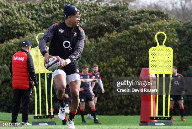 Anthony Watson runs with the ball during the England training session held at Pennyhill Park on March 14, 2018 in Bagshot, England.