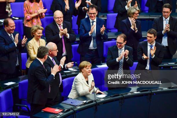 German Chancellor Angela Merkel is applauded after she was re-elected as Chancellor during a session at the Bundestag on March 14, 2018 in Berlin....