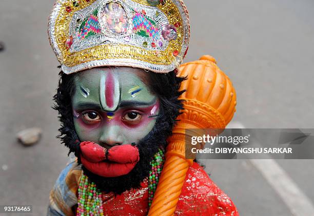 Ram Babu dressed as Hindu ape god Hanuman, begs on the side of a busy road in Bangalore on November 18, 2009. Babu dresses like different Hindu gods...