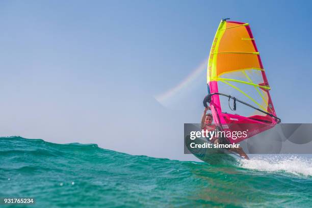 windsurfing on sea - aquatic sport stock pictures, royalty-free photos & images