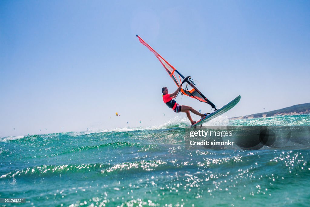 People doing kitesurfing and windsurfing