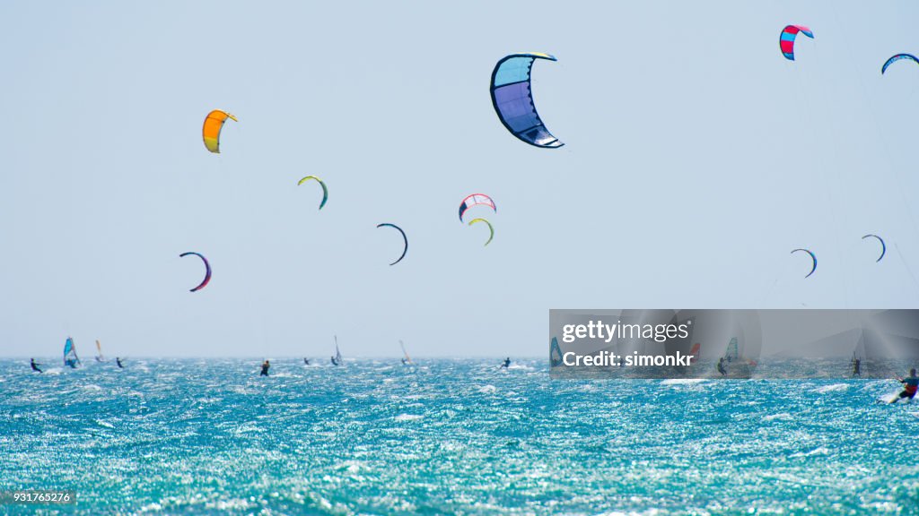 People doing kitesurfing and windsurfing