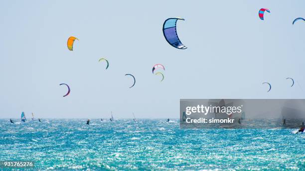 people doing kitesurfing and windsurfing - kite surfing stock pictures, royalty-free photos & images