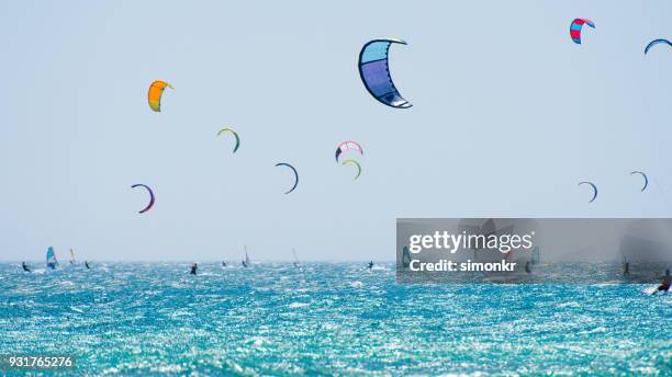 people doing kitesurfing and windsurfing - kiteboarding stock pictures, royalty-free photos & images