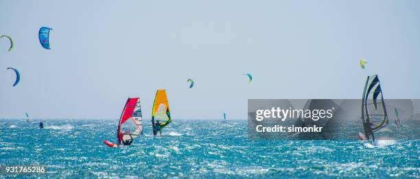 people doing kitesurfing and windsurfing - wind surfing stock pictures, royalty-free photos & images