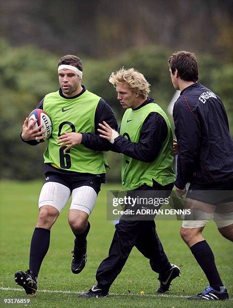 England rugby union player Joe Worsley runs with the ball beside team-mate Lewis Moody during a training session at Pennyhill Park near Bagshot, on...