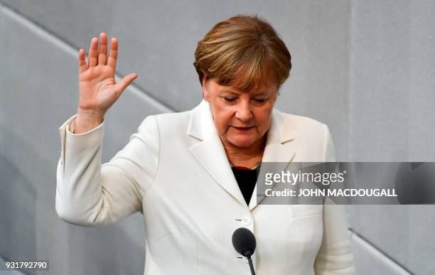 German Chancellor Angela Merkel is sworn in by the President of the German lower house of Parliament Bundestag during the government's swearing-in...