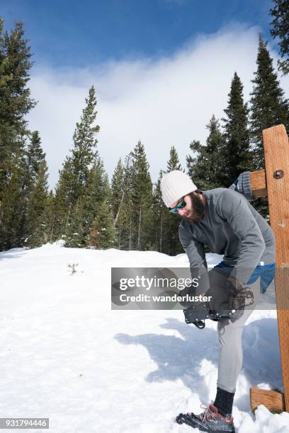 man prepares to run on snowy trails in forest - running spikes stock pictures, royalty-free photos & images