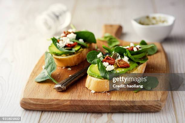healthy spinach and avocado bruschetta - bruschetta stock pictures, royalty-free photos & images