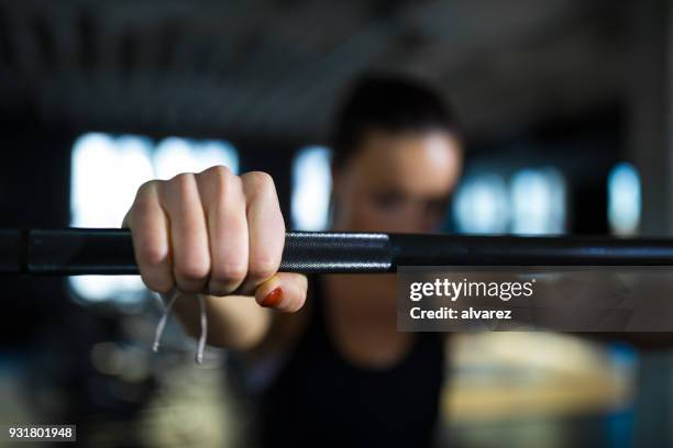 cropped image of athlete gripping barbell in gym - womens hand weights stock pictures, royalty-free photos & images