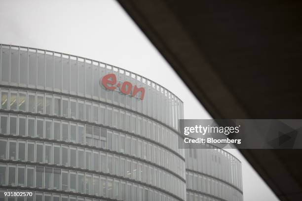 Logo sits on the exterior the EON SE headquarters in Essen, Germany, on Tuesday, March 13, 2018. EON will shed as many as 5,000 jobs in the deal to...