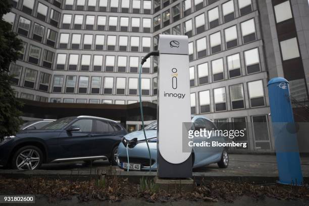 An electric automobile charging station, operated by Innogy SE, stands outside the headquarters of RWE AG in Essen, Germany, on Tuesday, March 13,...