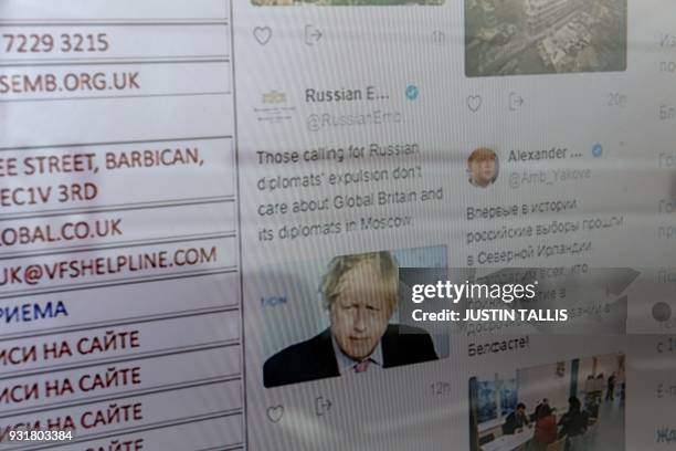 The Russian Embassy social media feed is displayed on a screen outside the Russian consulate in London on March 14, 2018. / AFP PHOTO / Justin TALLIS